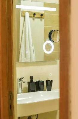 a bathroom with a sink and a mirror at Stylish apartment with pool access heart of Marrakech gueliz in Marrakech