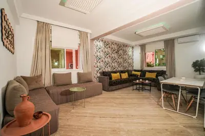 a living room with a couch and a table at Stylish apartment with pool access heart of Marrakech gueliz in Marrakech