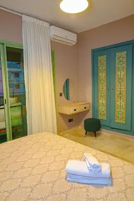 a bedroom with a bed and a desk and a mirror at Appartement HIVERNAGE deLUXE en face consulat de france et M avenu CR7 in Marrakech