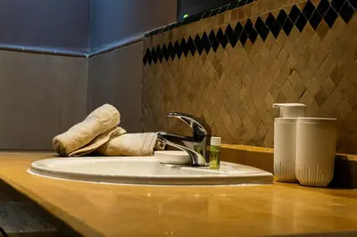 a bathroom sink with a faucet and a towel at Appartement HIVERNAGE deLUXE en face consulat de france et M avenu CR7 in Marrakech