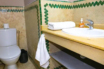 a bathroom with a toilet and a sink at Appartement HIVERNAGE deLUXE en face consulat de france et M avenu CR7 in Marrakech