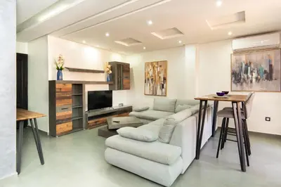 a living room with a couch and a table at Beautiful central apartment in Marrakech