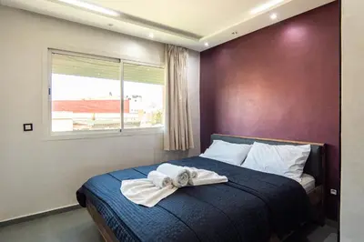 a bedroom with a bed with a towel on it at Beautiful central apartment in Marrakech
