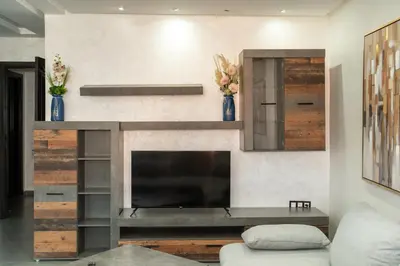 a living room with a tv and a fireplace at Beautiful central apartment in Marrakech