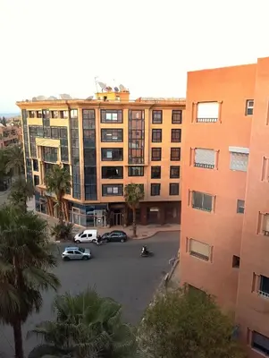 an aerial view of a parking lot in front of a building at Beautiful central apartment in Marrakech