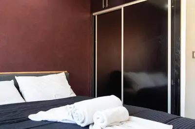 a bedroom with a bed with towels on it at Beautiful central apartment in Marrakech