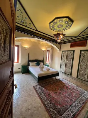 a large bedroom with a bed and a rug at Royal Arabian Night in Marrakech