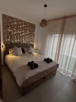 a bedroom with a bed with two black saddles on it at Villa Marrakech DAR JAHYR in Douar Ouled Ahmed