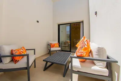 a living room with two chairs and a table at Beautiful new villa with private pool in El Rhechat