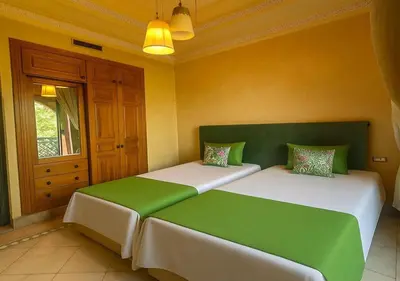 two beds in a room with green and white at L'Oasis Chic Palmeraie Marrakech Piscine & Petit Déj Offert in Marrakech