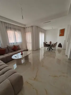 a living room with a couch and a table at Sumptuous apartment in Premium Village in Marrakech