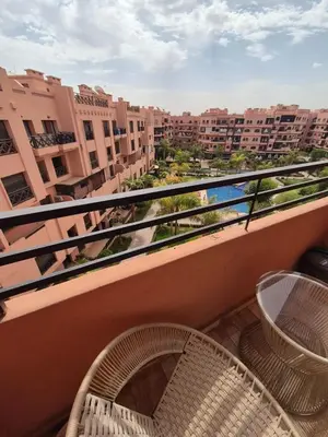 a balcony with two chairs and a view of a city at Sumptuous apartment in Premium Village in Marrakech