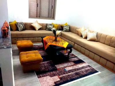 a living room with a couch and a table at 2-bedroom apartment in Marrakech