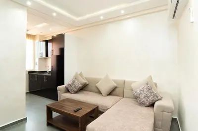a living room with a couch and a table at Cozy apartment in the hypercenter in Marrakech