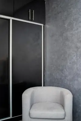 a white chair in a room with a wall at Cozy apartment in the hypercenter in Marrakech