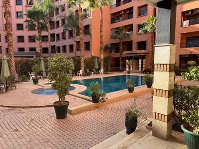 a courtyard with a swimming pool in a building at Marrakech Apartment Hivernage in Marrakech