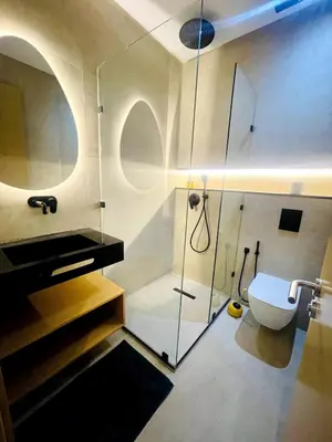 a bathroom with a glass shower and a toilet at Superb apartment with all amenities and pool in Marrakech