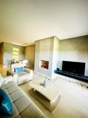 a living room with a couch and a fireplace at Superb apartment with all amenities and pool in Marrakech