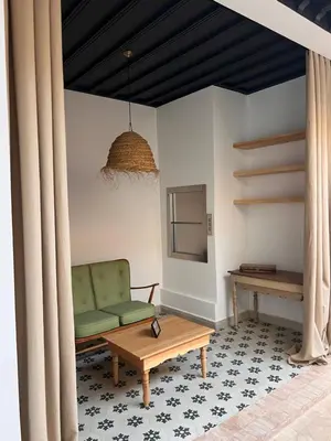 a living room with a green couch and a table at Riad Bergamot in Marrakech