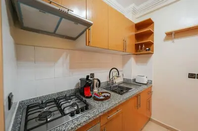 a kitchen with a stove and a counter top at NS 51 by KMREI Properties in Marrakech