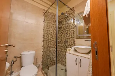 a bathroom with a shower and a toilet and a sink at NS 51 by KMREI Properties in Marrakech