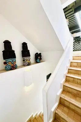 a staircase in a house with three cats on shelves at Riad Bab Sitiyn Hammam & Spa in Marrakech