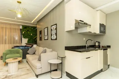 a kitchen and living room with a couch and a table at Luxurious apartment ,hot tub in Marrakech