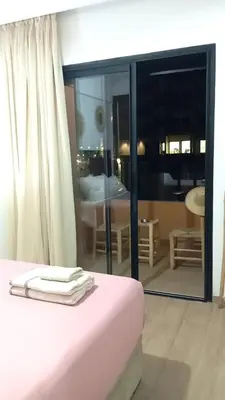 a room with a bed and a view of a living room at Two bedroom apartment - Guéliz train station in Marrakech