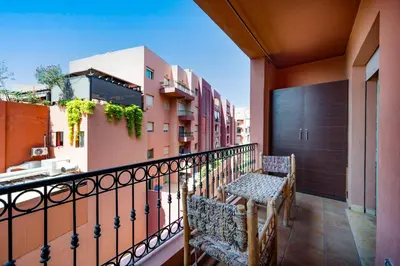 a balcony with a table and chairs on a building at Studio cosy avec piscine et balcon Résidence Mirador Majorelle in Marrakech