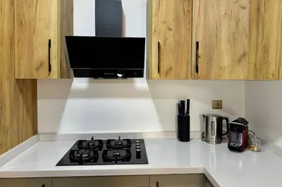 a kitchen with a stove and a microwave at Top floor apartment in Gueliz with Balcony in Marrakech