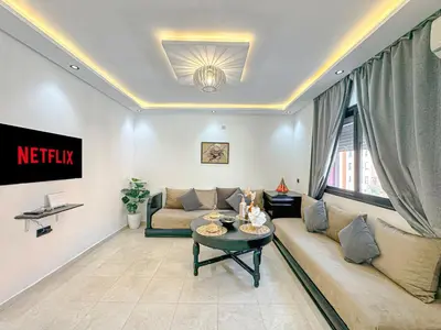 a living room with a couch and a table at Lumière d'Atlas Calme et Confort in Marrakech
