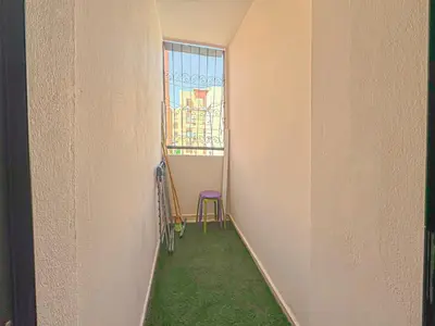 a hallway with a window and a chair in a room at Lumière d'Atlas Calme et Confort in Marrakech