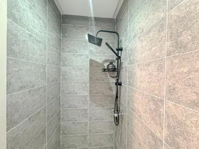 a shower with a shower head in a bathroom at Lumière d'Atlas Calme et Confort in Marrakech
