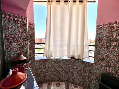 a window with a curtain in a room at Nelbrj Studio in Marrakech