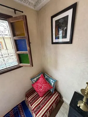 a corner of a room with two pillows on a bench at Échappée onirique au cœur de Marrakech in Marrakech