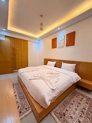 a bedroom with a large bed with white sheets at Orange Apartment With Pool in Marrakech