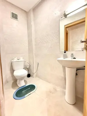 a bathroom with a toilet and a sink at Orange Apartment With Pool in Marrakech