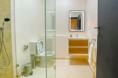 a bathroom with a toilet and a sink and a mirror at 2 bedrooms appartement les palmiers de targa in Marrakech