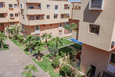 an aerial view of an apartment complex with palm trees at 2 bedrooms appartement les palmiers de targa in Marrakech