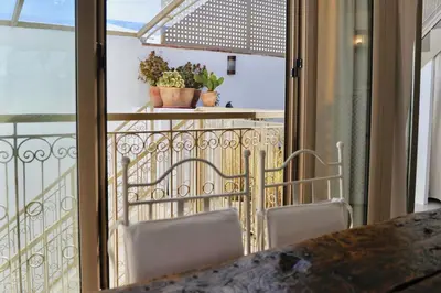 a balcony with two chairs and a table at Riad KITSCH in Marrakech
