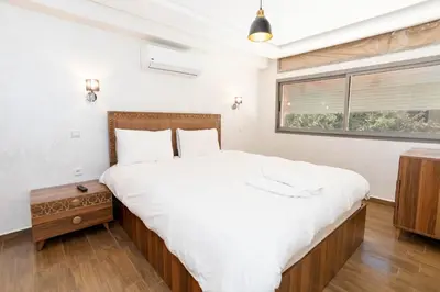 a bedroom with a large bed and a window at Bonheur appartement in Marrakech