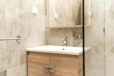 a bathroom with a sink and a shower at Luxury Balnéo appartement in Marrakech