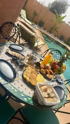 a table with a plate of food on top of it at Villa Dar Soka in Marrakech