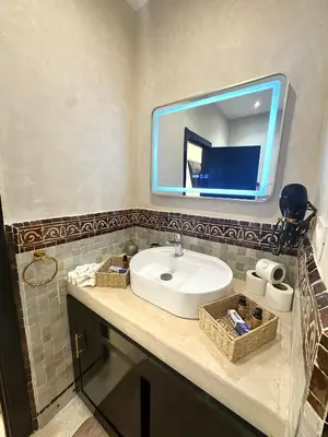 a bathroom with a sink and a mirror at Villa Dar Soka in Marrakech