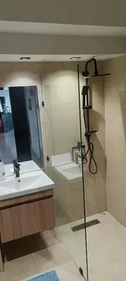 a bathroom with two sinks and a mirror and a shower at premium village m231 in Marrakech