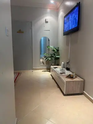 a living room with a flat screen tv on the wall at Modern Comfort, Local Vibes in Marrakech