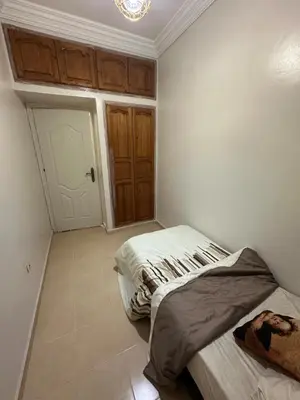 a bedroom with two beds in a room with a door at Modern Comfort, Local Vibes in Marrakech