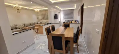 a kitchen and living room with a table and chairs at Medali in Lahebichate