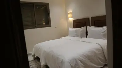 a bedroom with a bed with white sheets and a window at Medali in Lahebichate