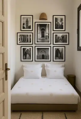a bedroom with a white bed with pictures on the wall at PRIVATE HOUSE in Medina Close to Jeema El Fna in Marrakech